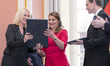 Berlin's Mayor Michael Mueller (R) and Family Minister Manuela Schwesig (L) award Melinda...
