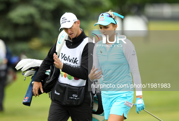 Lexi Thompson of the United States talks to caddy on the 11th hole during the first round of the LPGA Volvik Championship at Travis Pointe C...