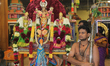 Tamil Hindu devotees escort the idol of Lord Murugan (along with his two wives Goddess Val...