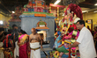 Tamil Hindu devotees escort the idol of Lord Murugan (along with his two wives Goddess Val...