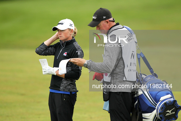 Stacy Lewis of the United States and caddie wait in the fairway of the 18th hole during the first round of the LPGA Volvik Championship at T...
