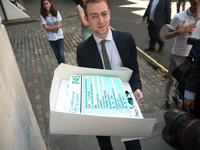 A men is pictured with a 'P45' cake dedicated to Labour Party Leader, Jeremy Corbyn, London on May 26, 2017. In the United Kingdom and the R...