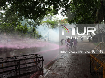 Bangladesh police fire a water cannon as left wing students march in the street towards the Supreme Court to protest in Dhaka on May 26, 201...