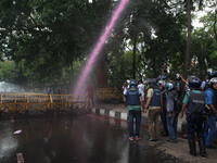 Bangladesh police fire a water cannon as left wing students march in the street towards the Supreme Court to protest in Dhaka on May 26, 201...