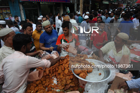 People gather to buy foods for breaking their fast during the Muslims holy fasting month of Ramadan at the traditional food market popular f...