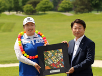 Shanshan Feng of China and Kyung Ahn Moon, Chairman of Volvik INC pose for a photo after winning the Volvik Championship at Travis Pointe Co...