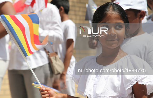 Sri Lankan girl holds a Buddhist flag during the festival of Vesak in Mississauga, Ontario, Canada, on 28 May 2017. Vesak (Wesak) commonly k...