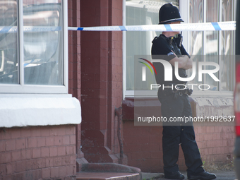 A police officer guards the cordoned off area of a street, where part of the investigation in to the Manchester Arena explosion is taking pl...