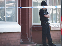 A police officer guards the cordoned off area of a street, where part of the investigation in to the Manchester Arena explosion is taking pl...