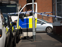 A police van guards the cordoned off area of a street, where part of the investigation in to the Manchester Arena explosion is taking place,...