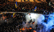 Pro-European integration protesters line up in front of riot police in Kiev. Ukrainian rio...