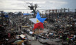 A giant Christmas lantern with the colors of the Philippine flag is seen in a devastated a...