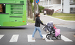 A young woman pushing a buggy with a flat tyre is seen in the center of Brest on 1 June, 2...