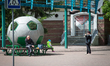 A woman is seen taking a photo with her phone at the entrance of the Brestsky sports compl...