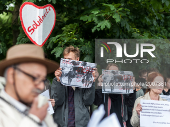 Afghans protesting against deportations hold up photos of today's bombing in Kabul outside the Afghan Embassy on June 7, 2017 in Berlin, Ger...