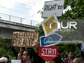 Afghans protesting against deportations hold up photos of today's bombing in Kabul outside the Afghan Embassy on June 7, 2017 in Berlin, Ger...