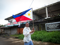 Civilian runs with a Philippine flag in war-torn Marawi City in preparation for the celebration of Independence Day on June 12, Lanao del Su...