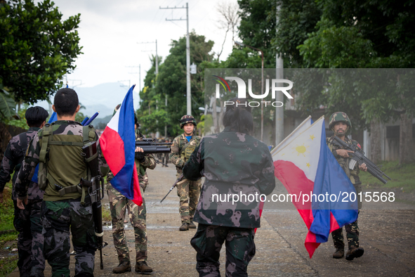 The Philippine National Police hang flags in war-torn Marawi City in preparation for the celebration of Independence Day on June 12, Lanao d...