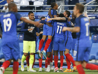 France's forward Ousmane Dembele (C) and France's midfielder Kylian Mbappe (C-L) celebrate with teammates after scoring during the internati...