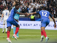 France's forward Ousmane Dembele (L) and France's midfielder Kylian Mbappe (R) celebrate after scoring during the international friendly foo...