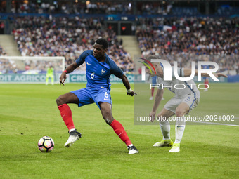 France's midfielder Paul Pogba (L) during the international friendly football match between France and England, on June 13, 2017 at the Stad...