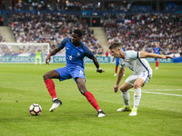 France's midfielder Paul Pogba (L) during the international friendly football match between France and England, on June 13, 2017 at the Stad...