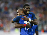 France's defender Djbril Sidibe (L) is embraced by teammate midfielder Paul Pogbaafter scoring during the international friendly football ma...