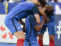 France's defender Djbril Sidibe is embraced by teammates after scoring during the international friendly football match between France and E...