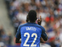 France's defender Samuel Umtiti celebrates after scoring during the international friendly football match between France and England at The...