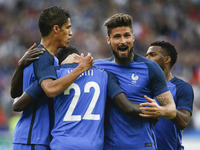 France's defender Samuel Umtiti (C/#22) is embraced by teammates after scoring during the international friendly football match between Fran...