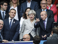 French Interior Minister Gerard Collomb (R) gestures as he stands alongside French President Emmanuel Macron (L) and Britain's Prime Ministe...