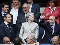 French Interior Minister Gerard Collomb (R) gestures as he stands alongside French President Emmanuel Macron (L) and Britain's Prime Ministe...