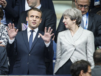 French President Emmanuel Macron (L) gestures as he stands alongside Britain's Prime Minister Theresa May (R) ahead of the international fri...