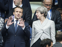 French President Emmanuel Macron (L) gestures as he stands alongside Britain's Prime Minister Theresa May (R) ahead of the international fri...