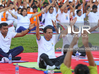 Sri Lankan president Maithripala Sirisena(C) performs Yoga during an event to mark the International Yoga Day at the Independence Square, Co...