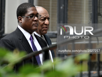 Bill Cosby, with spokesperson Andrew Wyatt (L), walks in upon arrival for the sixth day of deliberations the aggravated indecent assault tra...