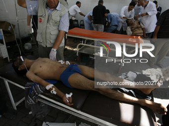 A wounded Palestinian man arrives at the hospital a after an Israeli air strike, in Rafah, in the southern Gaza Strip on August 3, 2014. At...