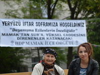 Two women wait at the park before the pro-Kurdish opposition Peoples' Democratic Party's (HDP) iftar dinner meeting in order to protest agai...