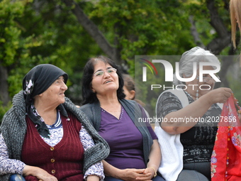 Elderly women wait at the park before the pro-Kurdish opposition Peoples' Democratic Party's (HDP) iftar dinner meeting in order to protest...