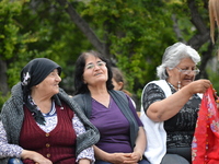 Elderly women wait at the park before the pro-Kurdish opposition Peoples' Democratic Party's (HDP) iftar dinner meeting in order to protest...