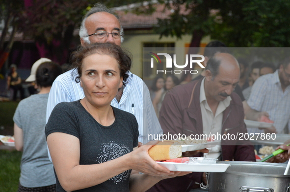 People carry their food platters at the pro-Kurdish opposition Peoples' Democratic Party's (HDP) iftar dinner meeting in order to protest ag...