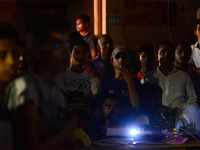 Iindian cricket fans watch India vs Pakistan final cricket match of Champions trophy , on a big projector  screen , in Allahabad on June 18,...