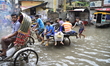 Citizens and Rickshaws try driving with passengers through the flooded streets of Dhaka af...