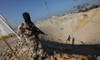 A Palestinian Islamic Jihad (PIJ) militant inspects a training camp which witnesses said w...