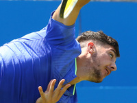 Thomas Kokkinakis  (AUS) agoinst mILOS Raonic (CAN)  during Round One match on the second day of the ATP Aegon Championships at the Queen's...
