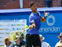 Thomas Kokkinakis  (AUS) agoinst mILOS Raonic (CAN)  during Round One match on the second day of the ATP Aegon Championships at the Queen's...