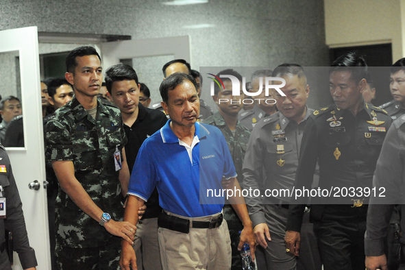 Watana Pumret (in blue shirt), suspected of a bomb attack on the military Phramongkutklao Hospital, is escorted by Thai soldiers and policem...