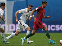 Tommy Smith (L) of the New Zealand national football team and André Silva of the Portugal national football team vie for the ball during the...