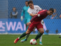Cristiano Ronaldo (L) of the Portugal national football team and Ryan Thomas of the New Zealand national football team vie for the ball duri...