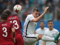 Pepe (L), Danilo Pereira of the Portugal national football team and Chris Wood of the New Zealand national football team vie for the ball du...